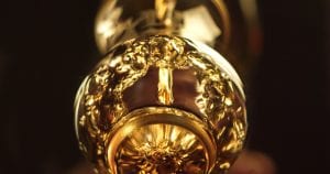 Close up still of whiskey being poured into a glass.