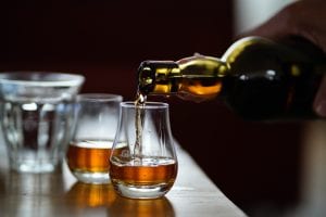 Whiskey being poured into a glass.